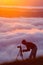 Photographer shooting natural phenomenon - the clouds that roam the mountains.