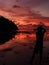 photographer shooting seascape with twilight sky