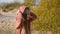 Photographer shoots a girl on the sand by the sea