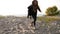 Photographer shoots a girl on the sand by the sea