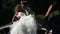photographer shoots by video camera bride and groom kiss