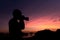 Photographer silhouette shooting seaand landscape outdoors at s