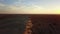 Photographer standing on the top of sand dune photographing the desert.