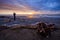 Photographer and sun set on black beach hokitika south island ne