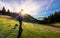 Photographer in sunburst shooting foggy landscape