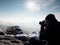 Photographer takes photos with camera on snowy peak