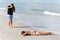 A photographer takes a picture of a woman on the beach, Florida,USA