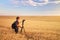 Photographer takes pictures in a wheat field.