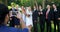 Photographer taking photo of bride and groom with there family 4K 4k