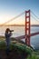 Photographer taking photo of Golden Gate Bridge