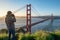 Photographer taking photo of Golden Gate Bridge