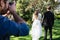 Photographer taking photo of newly married couple