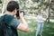 Photographer taking photos of blurred woman with reflector