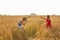 Photographer taking photos of girl model in a beautiful field