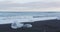 Photographer taking photos in nature on Iceland Diamond Beach with Ice