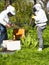 Photographer taking pictures of apiarist in garden