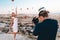 Photographer is taking shot of a woman at the background with Hot Air Balloons in Cappadocia