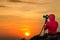 Photographer taking Thailand travel twilight sky photography. Woman photographer shooting with tripod and DSLR camera at sunset  w