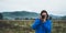 Photographer tourist girl in blue raincoat hold in female hands photo camera take photography froggy mountain, front traveler