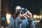 Photographer tourist girl with retro camera take photo on background bokeh light in evening city, Blogger photoshoot photo hobby