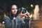 Photographer tourist girl with retro camera take photo on background bokeh light in evening europe city, Blogger photoshoot photo