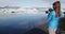 Photographer tourist on Iceland photographing Jokulsarlon glacier lagoon