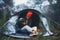 Photographer tourist traveler take photo on camera in camp tent in foggy rain forest, hiker woman shooting mist nature trip