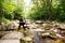 Photographer traveler on a mountain river