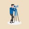 A photographer or videographer capturing content with camera and tripod.Cameraman standing with professional camera.A