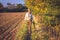 Photographer walking on footpath in autumn rural scenery