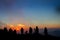 Photographers silhouetted against misty sunset in North Carolina mountains