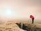 Photographr looking into viewfinder of dslr digital camera stand on tripod. Artist photographing mountain and cloudy landscape