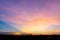 Photographs of the sky after the sunset, with colorful and shaded grasslands in the community crossing the horizon