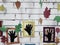 Photography abstract composition pictures black hands in colored frames on a background of a white brick wall with autumn leaves