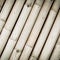 a photography of a bunch of bamboo poles with a brown background, pipe organ of bamboo sticks with a brown background