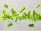 photography of CELERY falling from the sky, hyperpop colour scheme. glossy, white background Heap of celery sticks