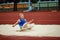 Photography highlights dynamic arc of long jump in exquisite detail. Professional, skilled sportsman landing in sand