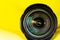 Photography lens aperture on a yellow background. Photo vision concept