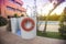 Photography of a lifeguard floart and a pool, a residential area during the sunset with palms and pool