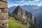 Photography of Machu Picchu ruins taken behind a great wall made of stone. Peru