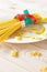 Photography of measuring tape wrapped around spaghetti on white plate. Dieting concept image