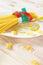 Photography of measuring tape wrapped around spaghetti on white plate. Dieting concept image