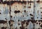 a photography of a rusted metal wall with a blue sky in the background, wrecked metal surface with rust and paint on it