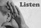 Photography of woman ear making listening gesture with her hand with word Listen