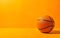 Photorealistic orange basketball ball isolated on warm yellow background, copy space. March madness poster design. Minimalistic