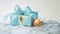 Photorealistic Painting Of Egg With Blue Bow On Gold Gift Box