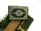 Photos of the Koran and prayer rugs ready for Ramadan.  Arabic on the cover is translated as the Qur'an