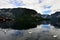 Photos of mountain and lake in Hallstatt of Austria with three swimming swans