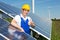 Photovoltaic engineer showing thumbs up at solar panel array