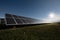 Photovoltaic installation with sunlight and clouds on the background